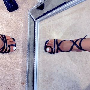 Brand new. Never been worn. Black strapped open toe heels